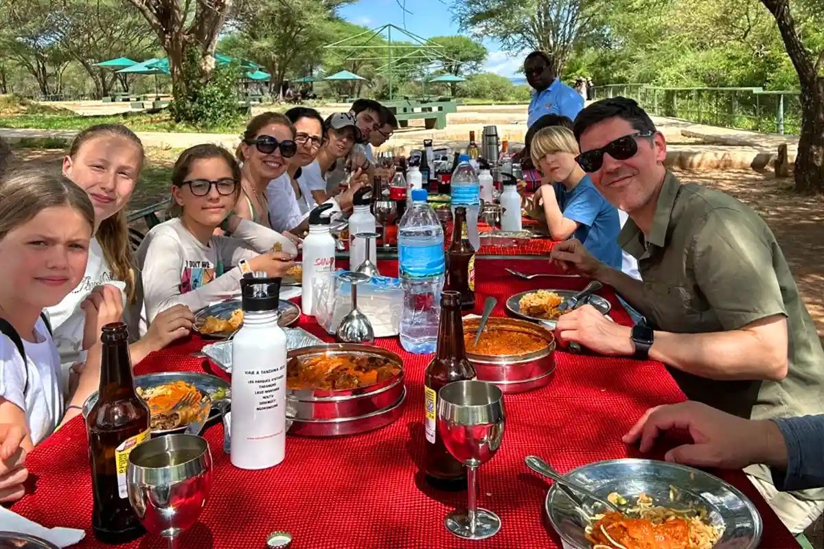 Family safari in Ngorongoro Crater with children spotting wildlife